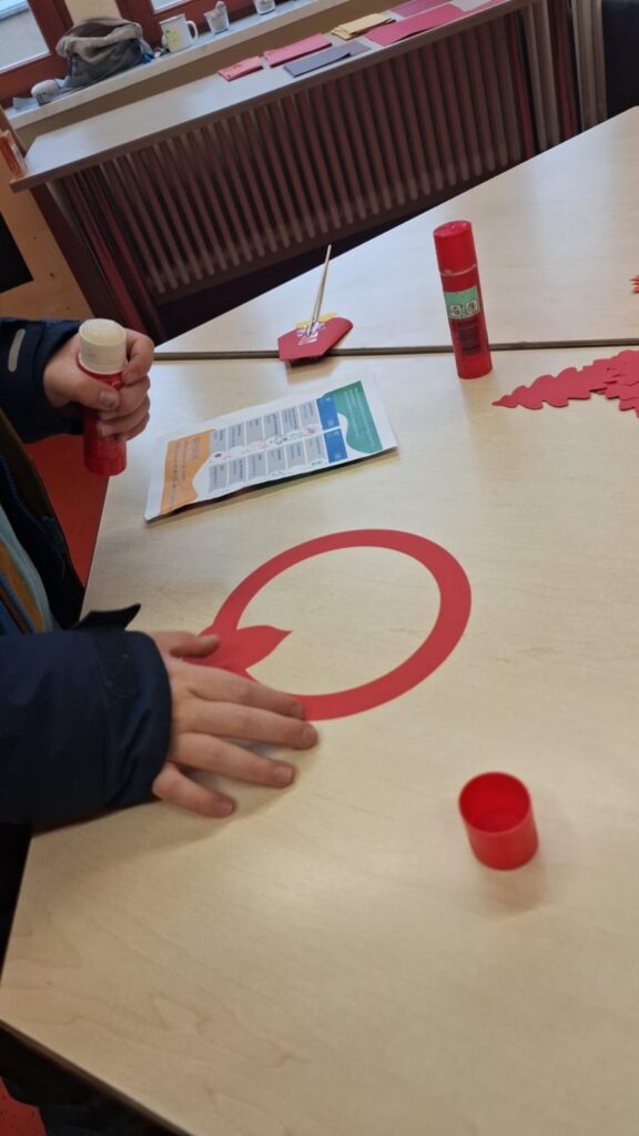 Kind bastelt mit Kleber.